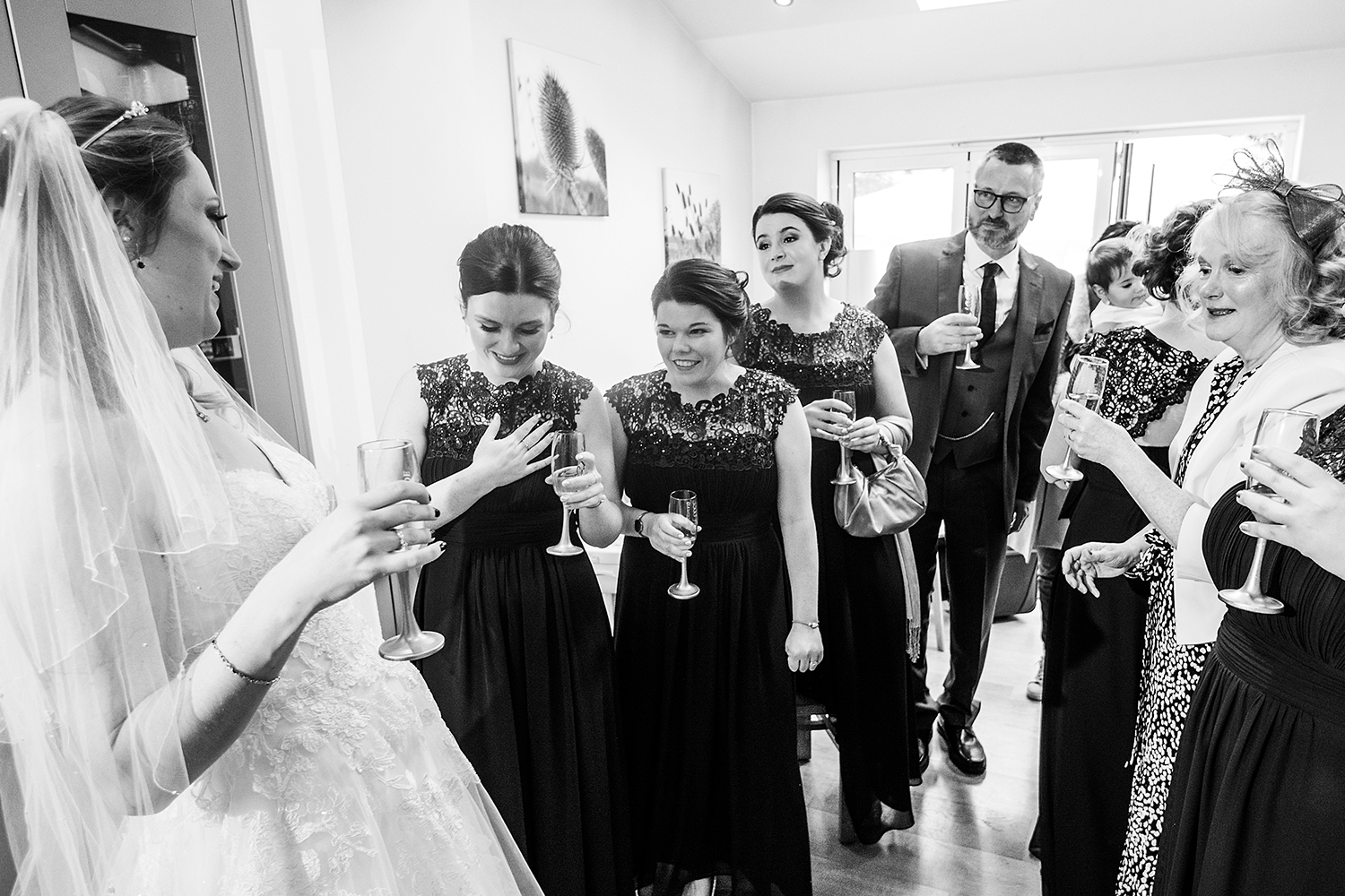 Bride with dress on and bridesmaids reaction by Beckenham Wedding photographer