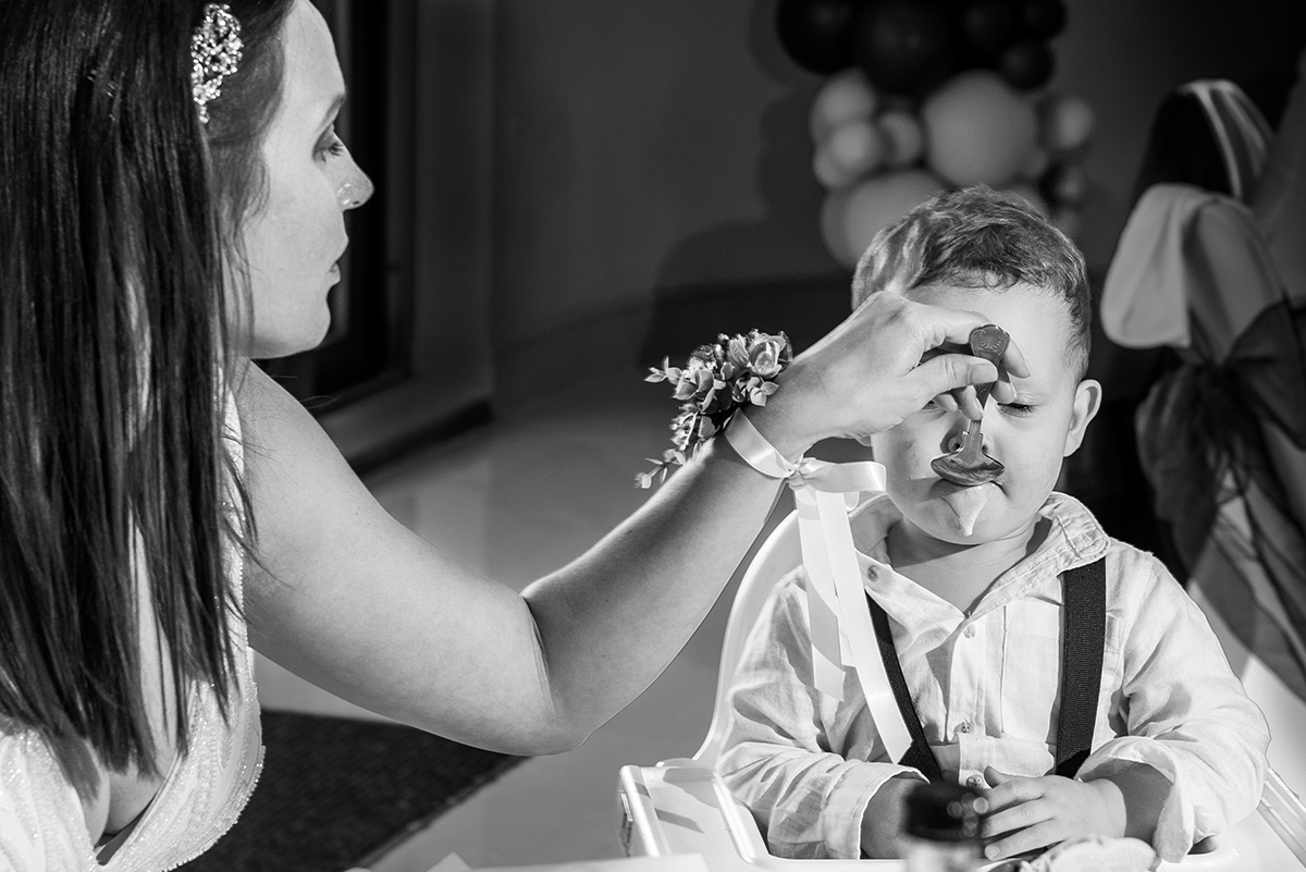 Bride feeding son at the reception by Documentary photographer in Bromley 