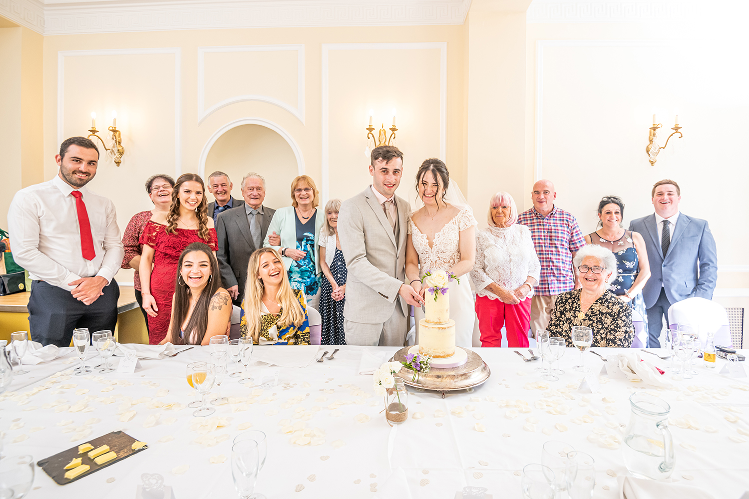 Cake Cutting Group Photo at the Bromley Court Hotel by Piccolino Weddings