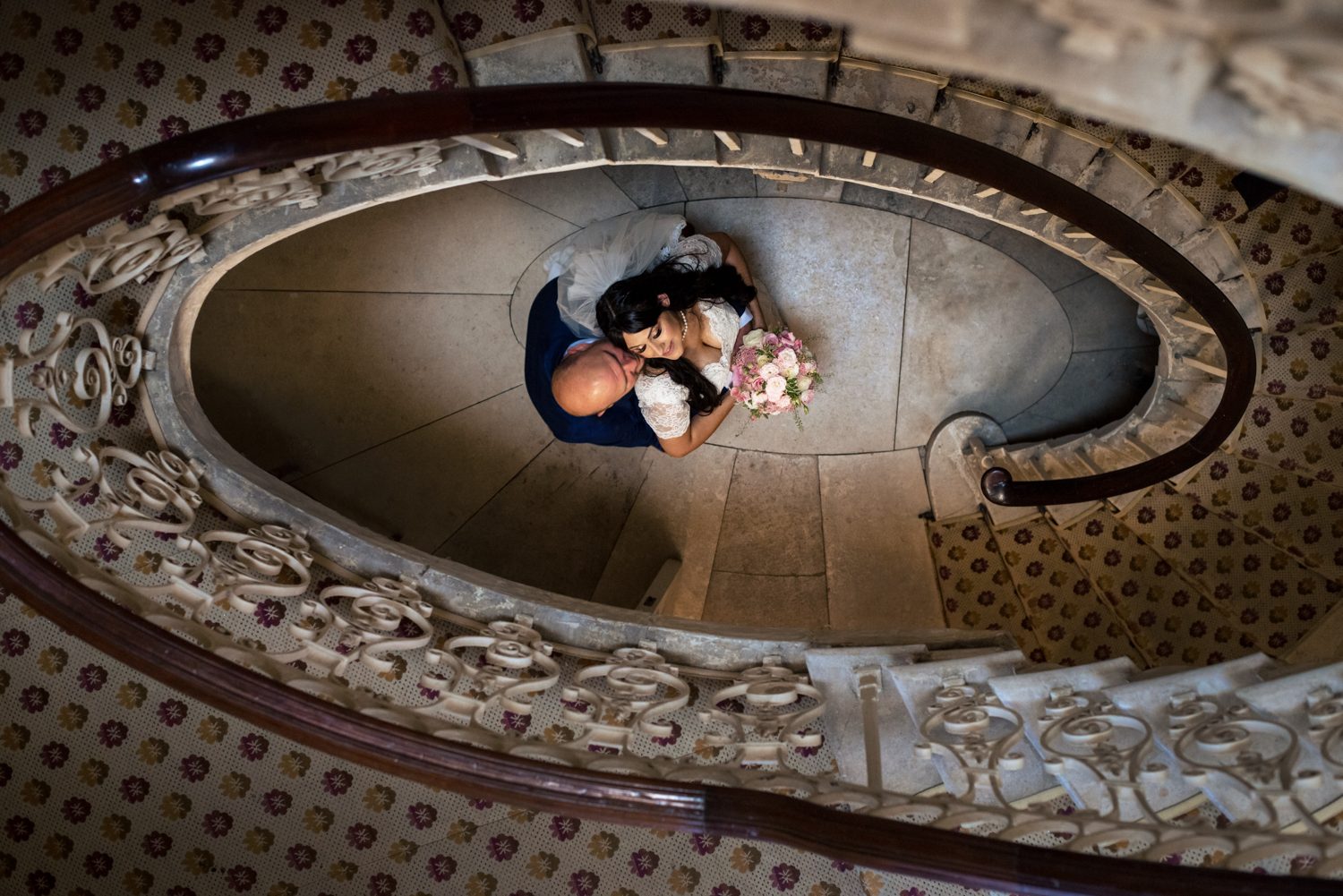 Couple portrait through the stairs