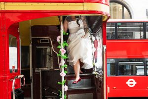 bride exiting a London Red Bus by South London Wedding photographer