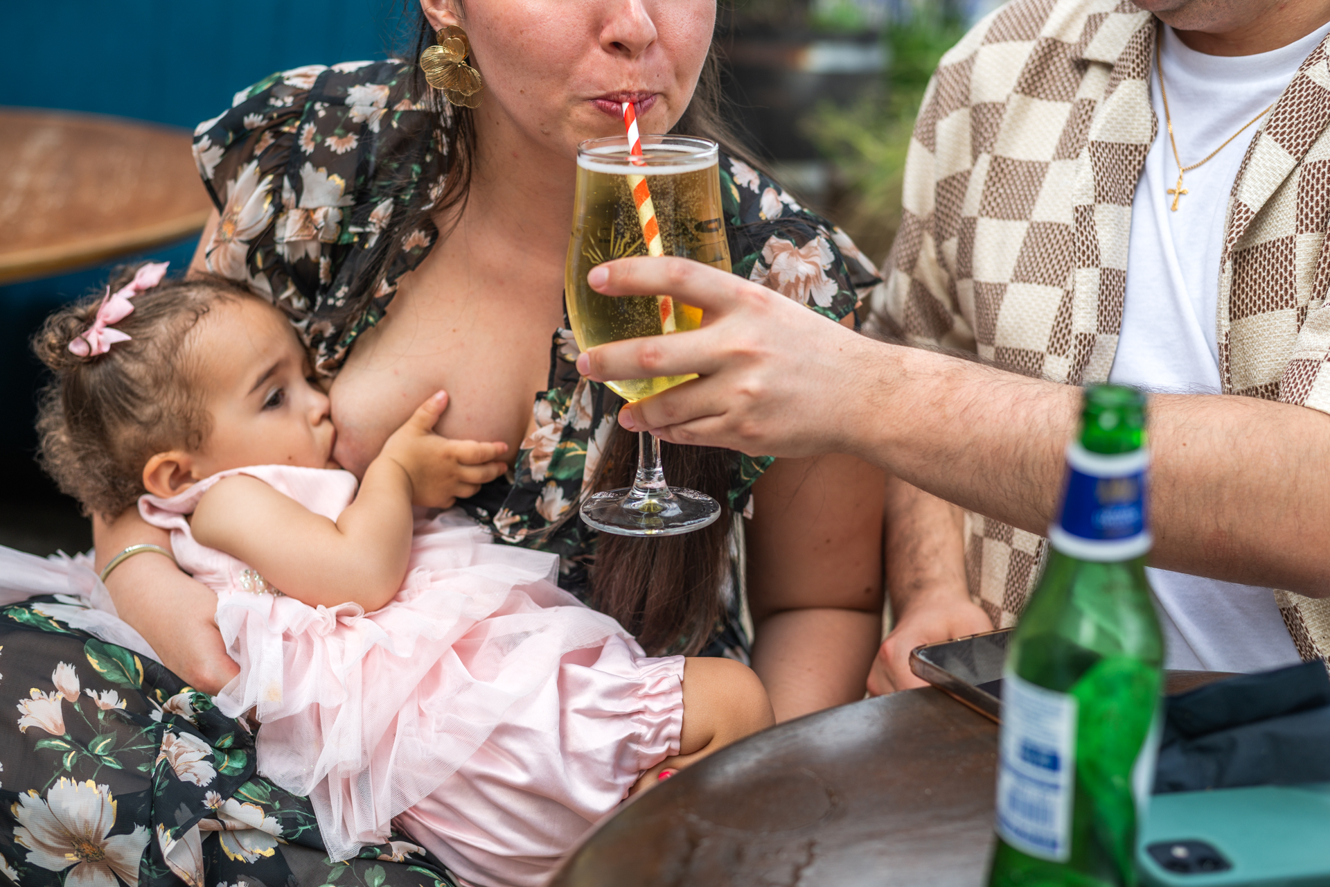 Wedding guest breastfeeding her child in a pub in lewisham during wedding reception