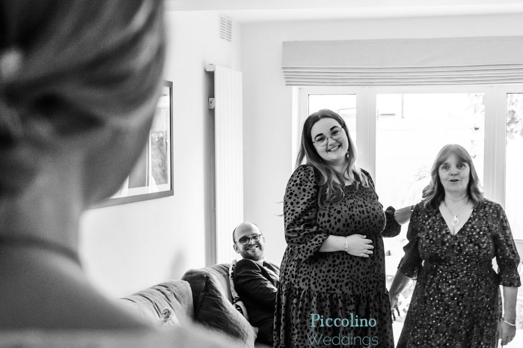 mum and sister looking at the bride with her dress on in her home in London before going to the ceremony at the Rosendale