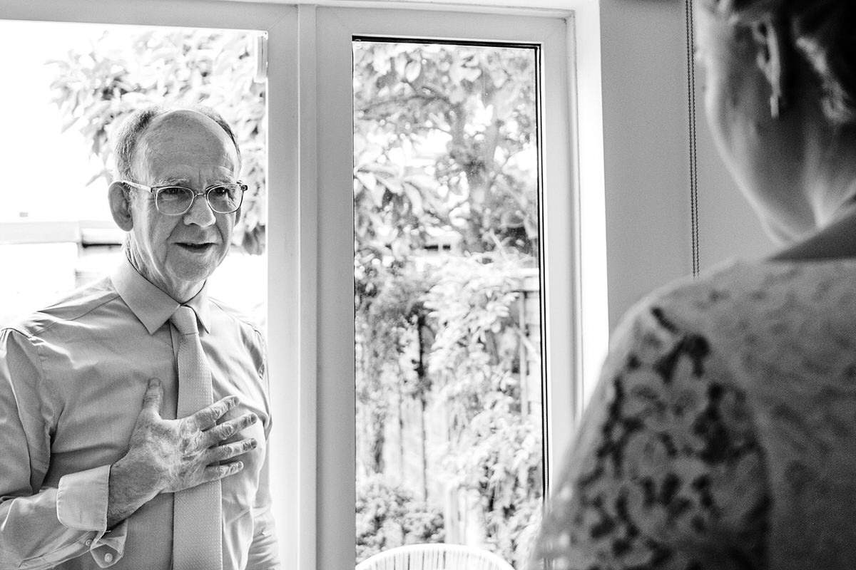 Father looking at his daughter for the first time before the wedding