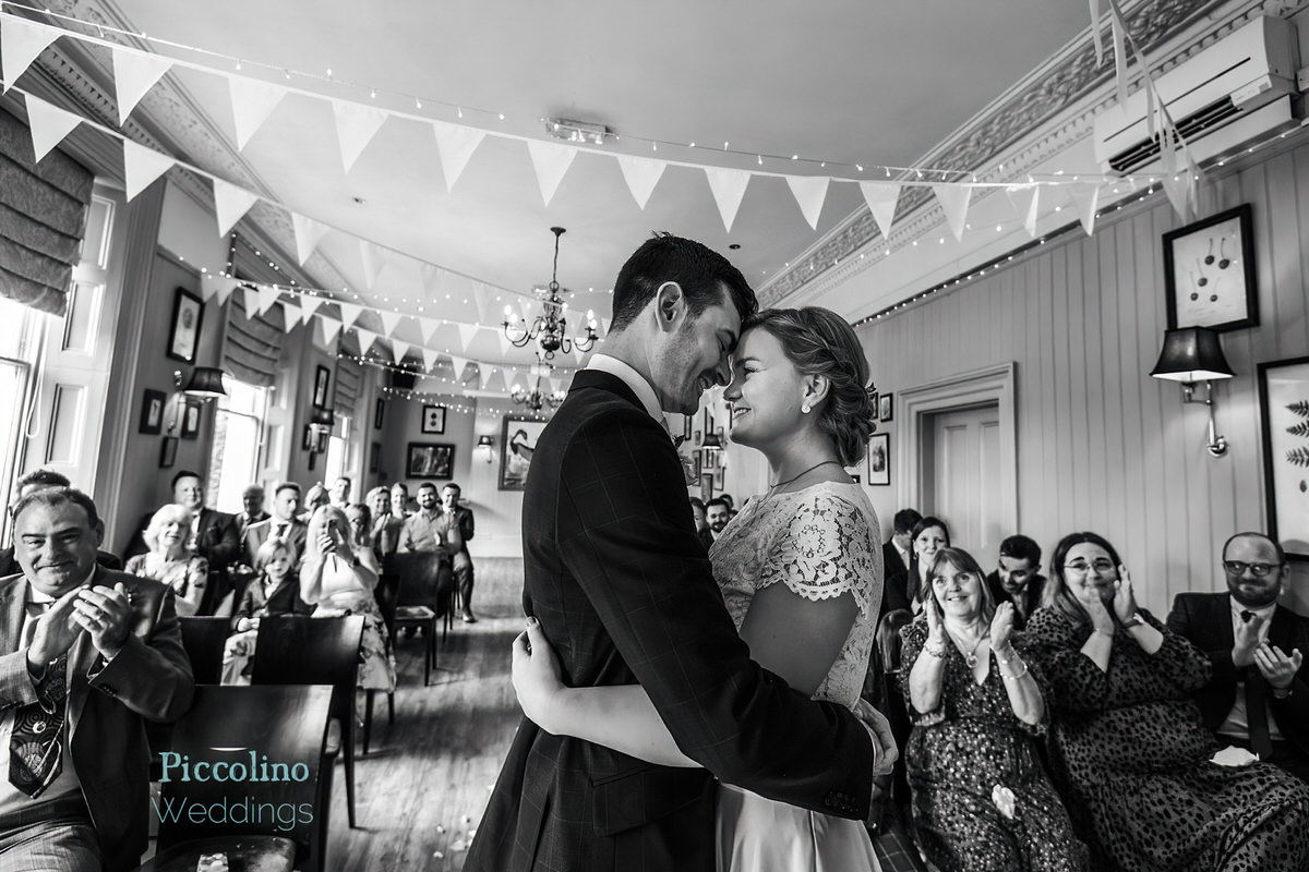 Wedding Couple kiss in the ceremony room in Dulwich