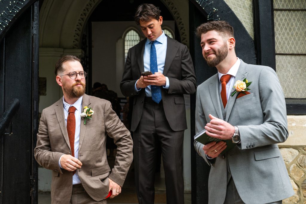 Groomsmen at the door of St John's Church, Dulwich, before the ceremony