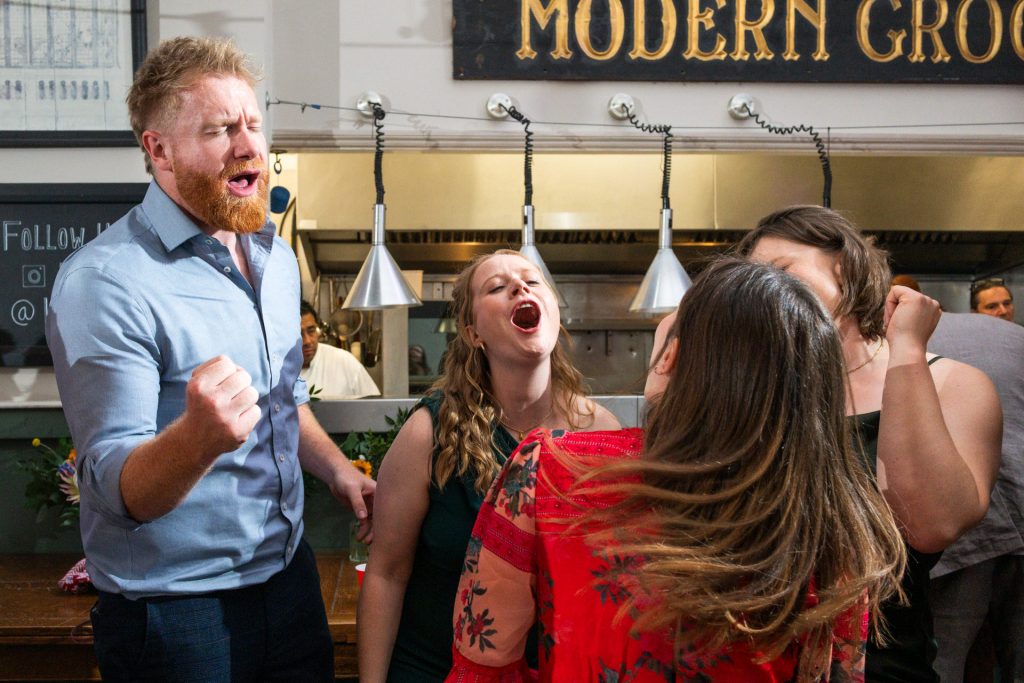 Guests singing along together during the evening reception at The Lordship Pub, Dulwich